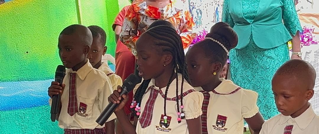 Students speaking at the microphone during assembly