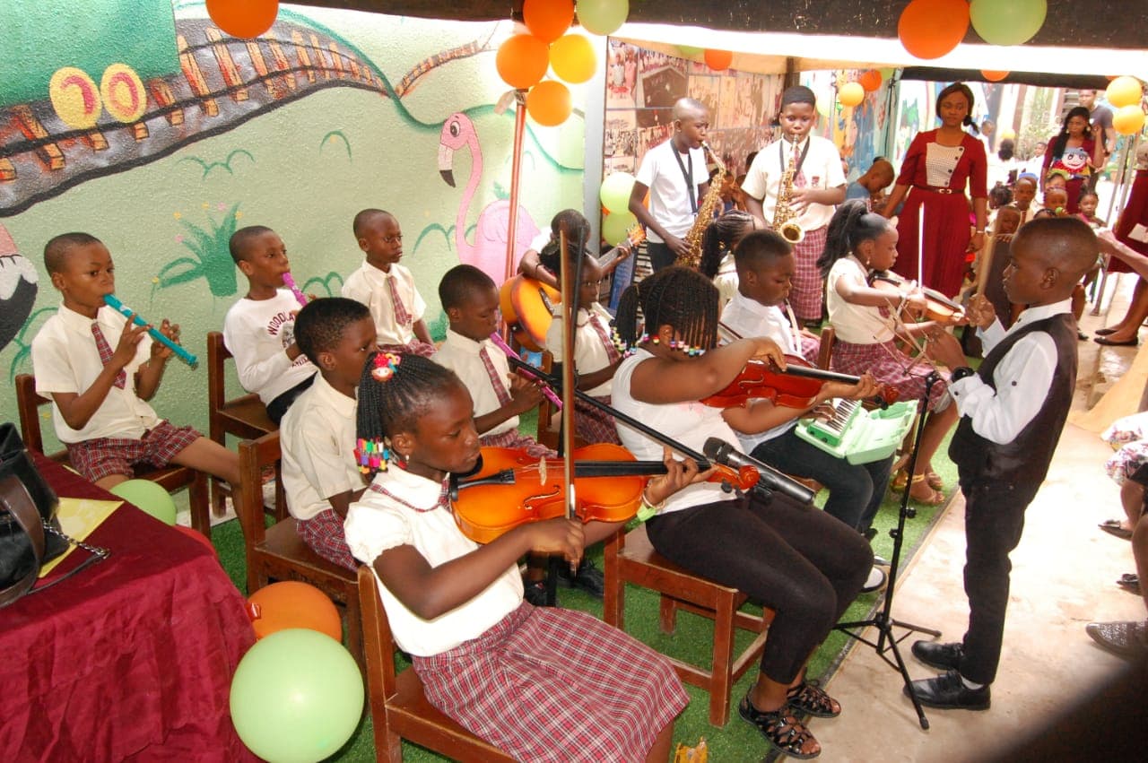 Student orchestra performing with violins and saxophones